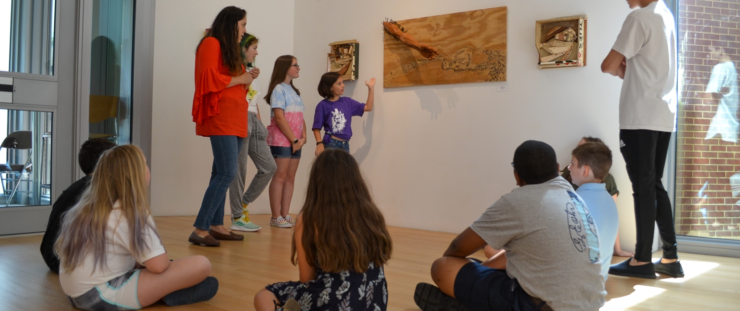 Summer campers discuss art in the galleries at OOMA