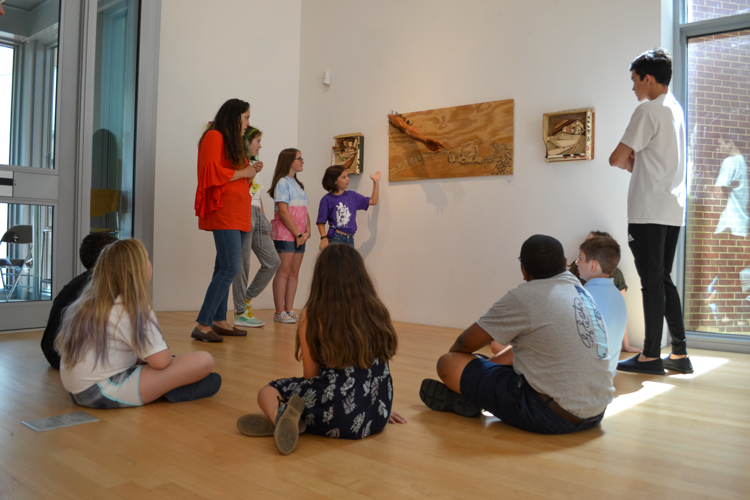 Summer campers discuss art in the galleries at OOMA