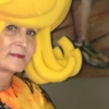 Paulette Dove paints in yellow costume