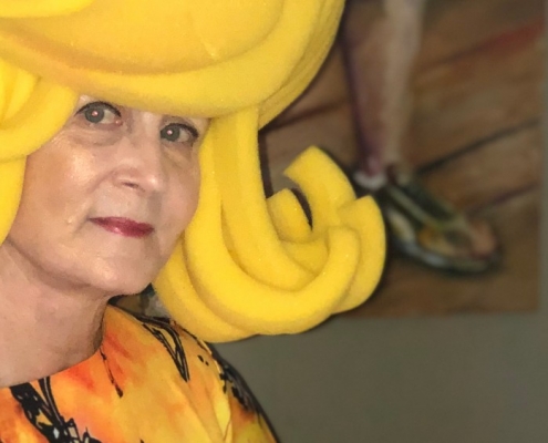 Paulette Dove paints in yellow costume