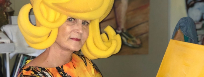 Paulette Dove paints in yellow costume